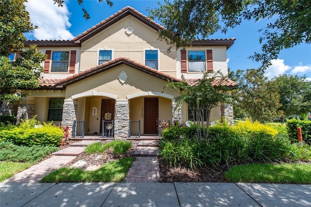 mediterranean / spanish-style home with covered porch