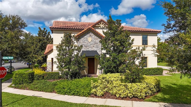 mediterranean / spanish-style home with a front lawn