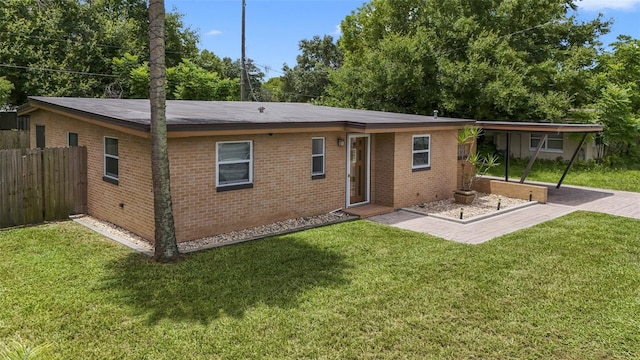 rear view of property with a yard