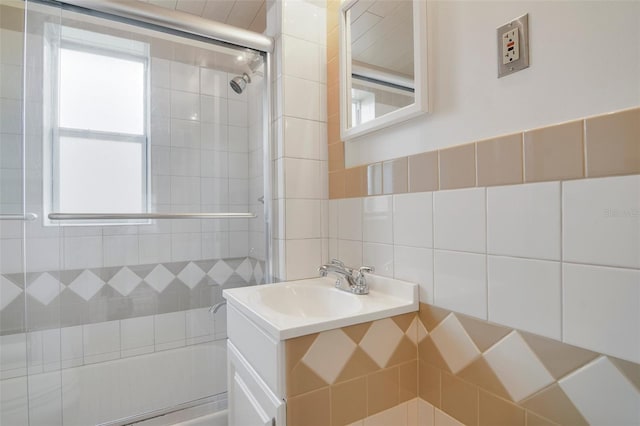 bathroom with vanity, backsplash, plenty of natural light, and tile walls