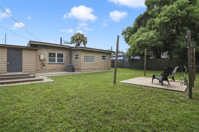 view of yard featuring central AC unit and a patio area