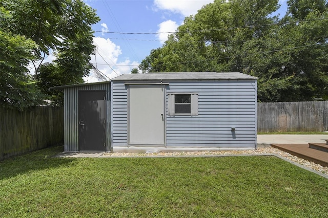 view of outdoor structure featuring a lawn