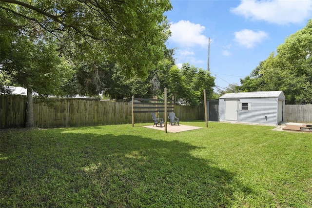 view of yard with an outbuilding and a patio area