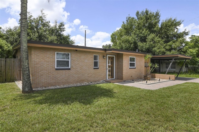 back of house with a patio and a yard