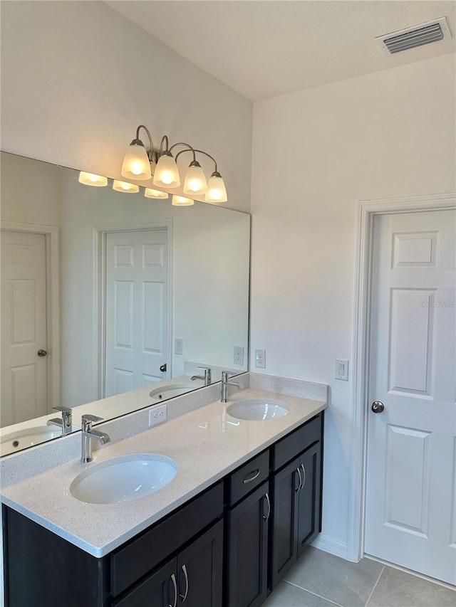 bathroom featuring tile patterned flooring and vanity