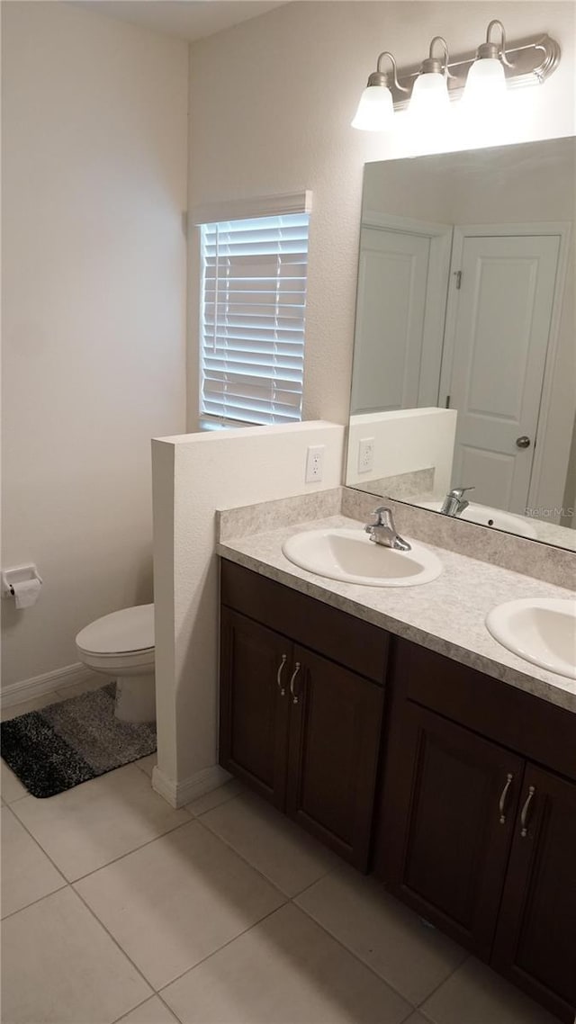 bathroom with vanity, toilet, and tile patterned flooring