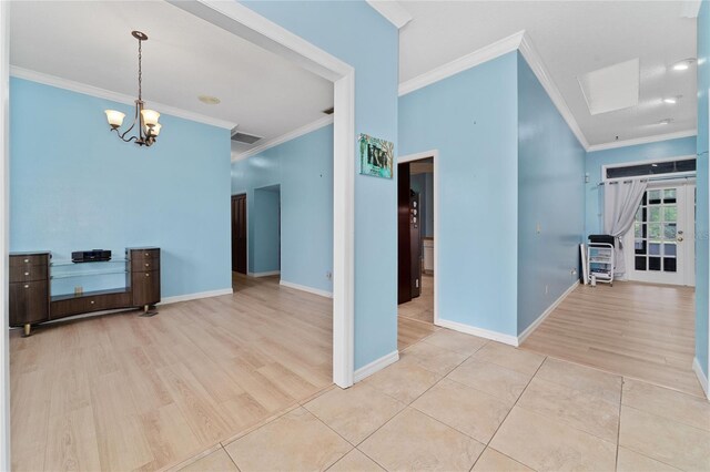 interior space with light hardwood / wood-style flooring, a chandelier, and ornamental molding