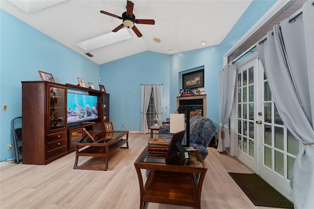 living room with ceiling fan, light wood-type flooring, and french doors