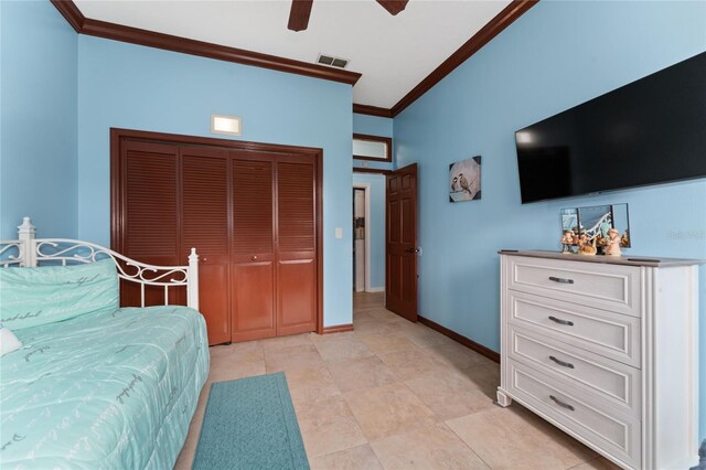 bedroom with ceiling fan, a closet, light tile patterned flooring, and ornamental molding