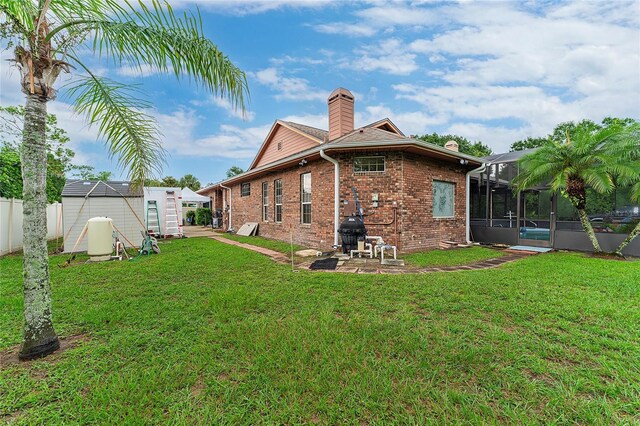 back of property featuring a lawn