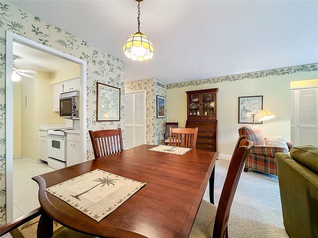 dining area featuring light carpet