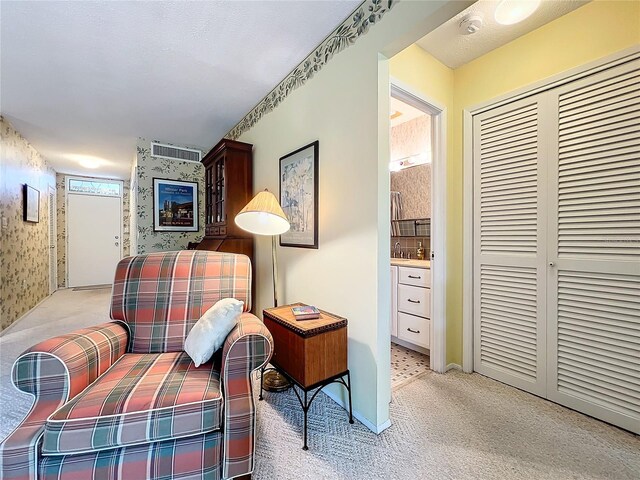 living area featuring light colored carpet