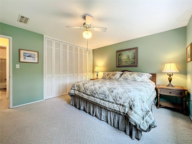 carpeted bedroom with a closet and ceiling fan