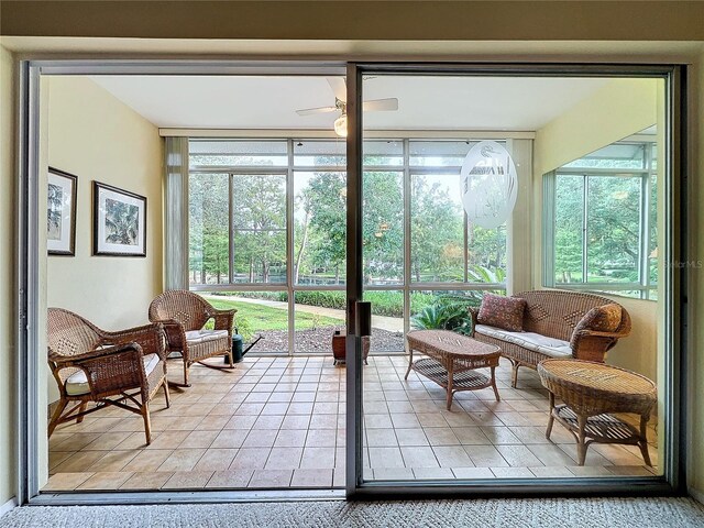 sunroom featuring ceiling fan