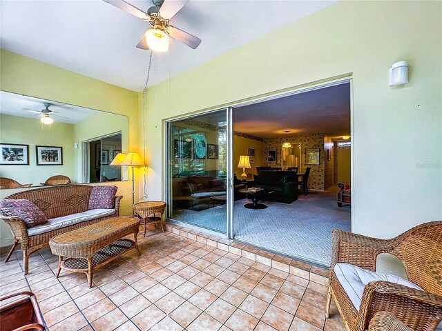 tiled living room with ceiling fan