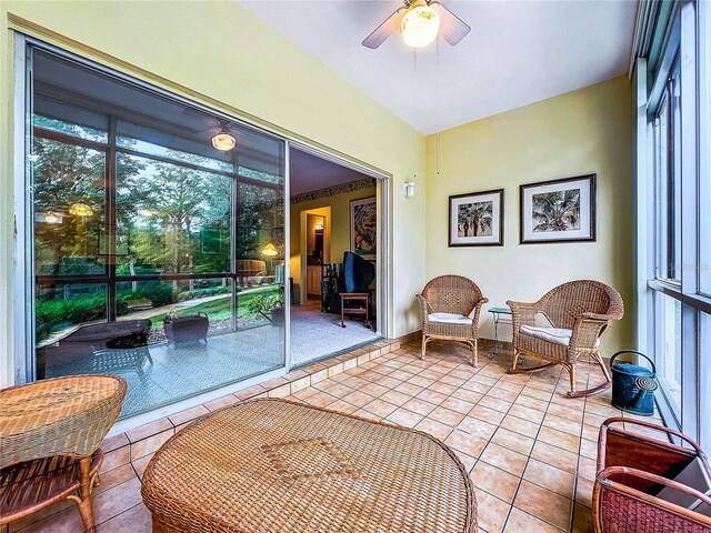 sunroom / solarium with ceiling fan and a healthy amount of sunlight