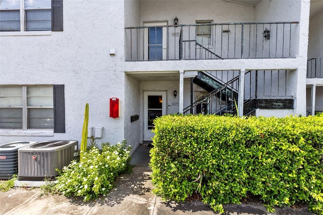 doorway to property featuring a balcony and cooling unit