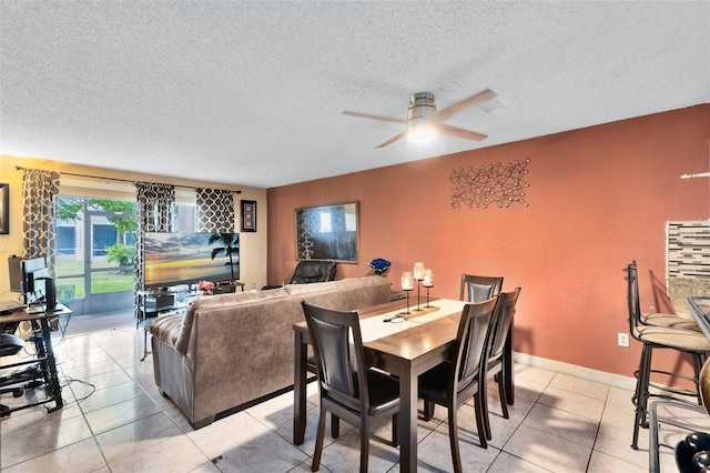 dining area featuring a textured ceiling, light tile patterned floors, and ceiling fan