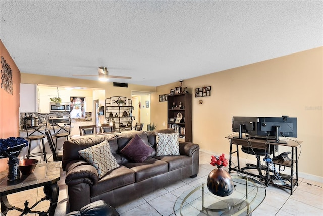 tiled living room featuring a textured ceiling and ceiling fan