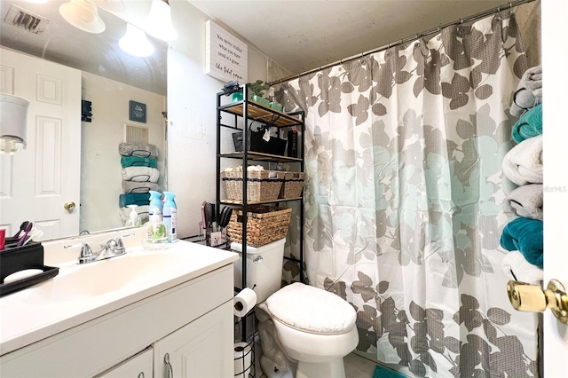 bathroom with toilet and vanity