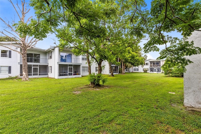 view of yard featuring a balcony