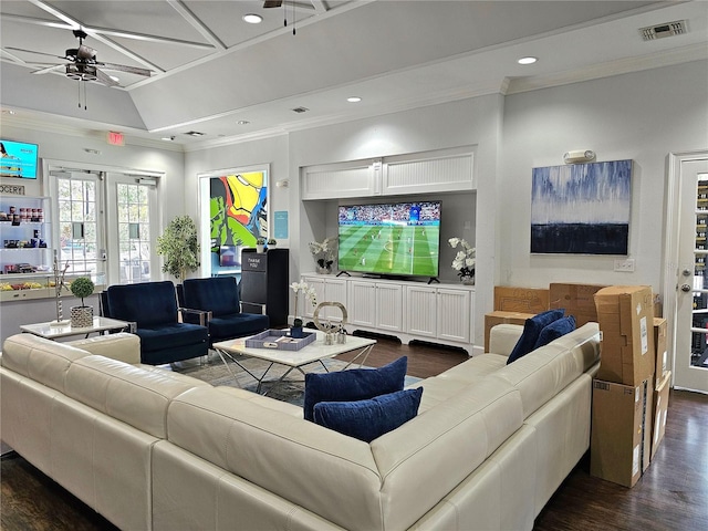 living room with ornamental molding, dark wood-type flooring, and ceiling fan