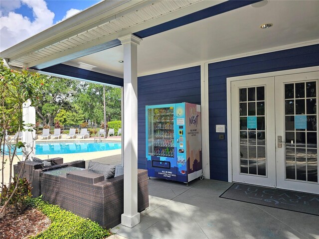 view of patio / terrace with french doors and a fenced in pool