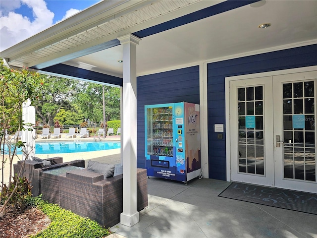 view of patio / terrace with a fenced in pool, outdoor lounge area, and french doors