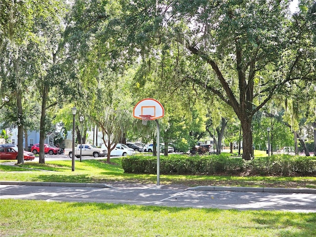 view of basketball court featuring a yard