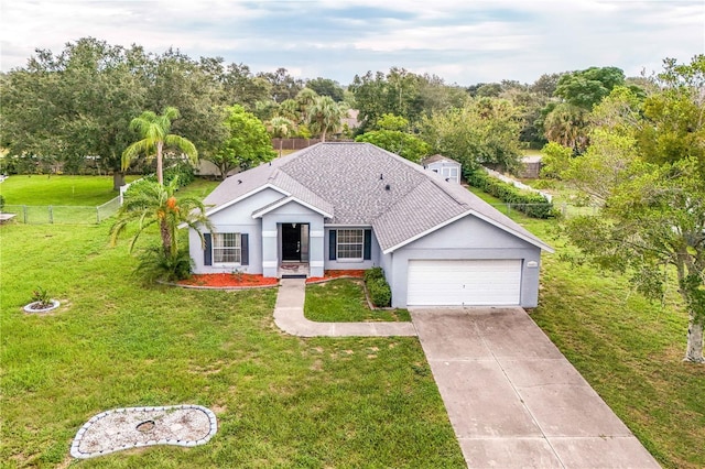 view of front of house with a garage and a front lawn