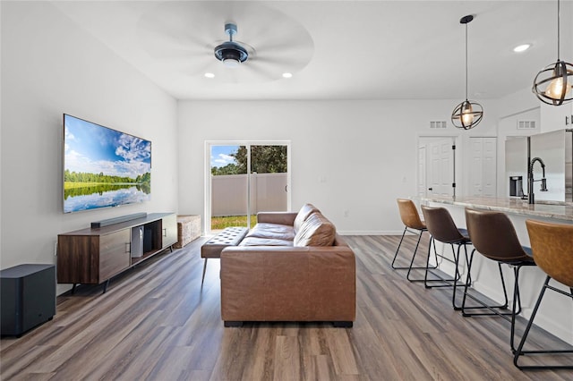 living room featuring hardwood / wood-style floors and ceiling fan