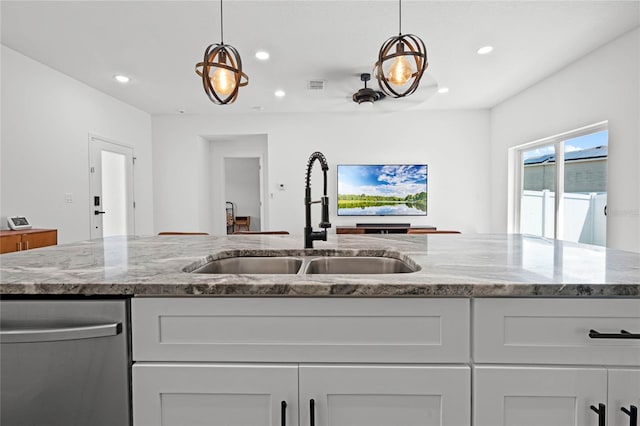 kitchen featuring white cabinetry, dishwasher, and light stone counters