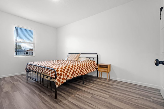 bedroom with hardwood / wood-style flooring