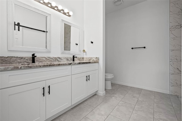 bathroom featuring vanity, tile patterned floors, and toilet