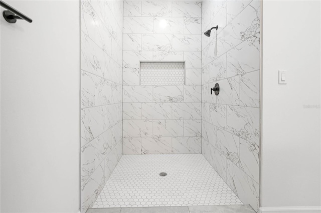 bathroom with tiled shower