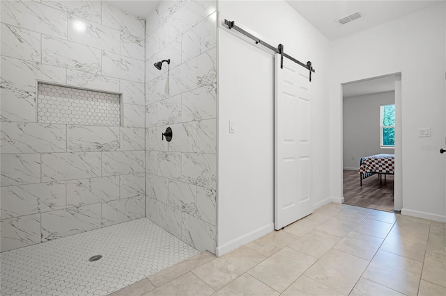 bathroom with tiled shower and hardwood / wood-style flooring