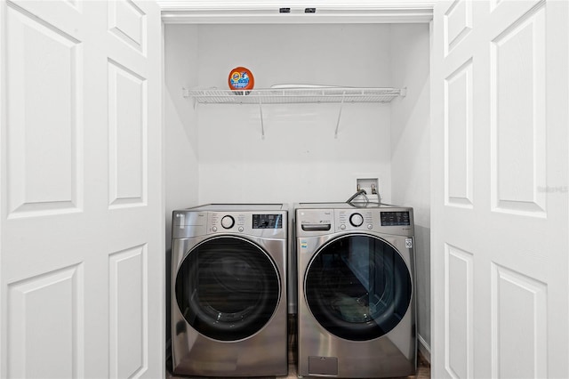 washroom with washing machine and clothes dryer