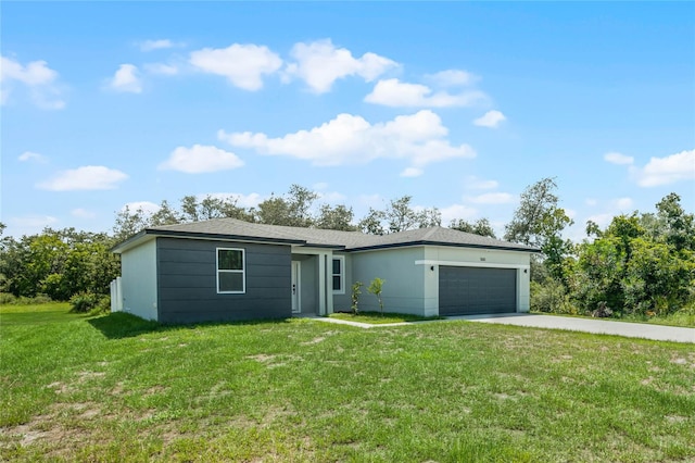 single story home with a garage and a front lawn