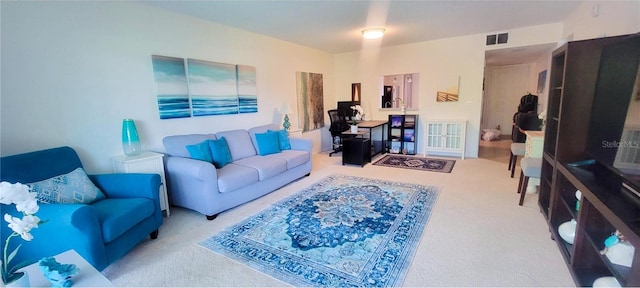 living area featuring visible vents and carpet floors