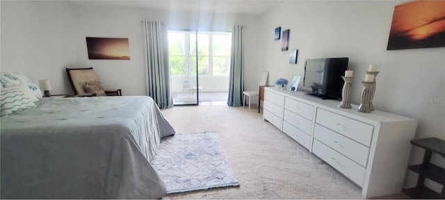 carpeted bedroom featuring access to outside