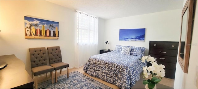 carpeted bedroom featuring a textured ceiling