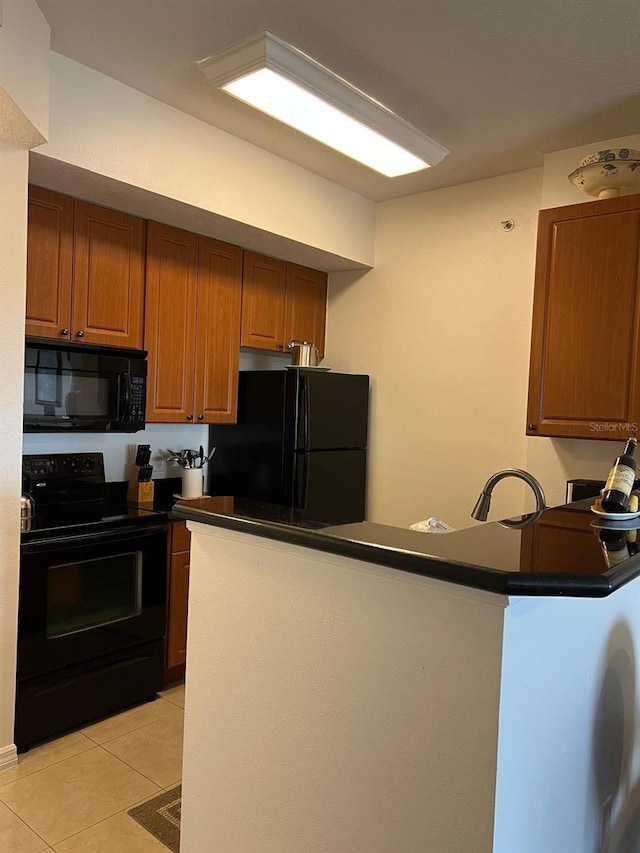 kitchen featuring kitchen peninsula, black appliances, and light tile patterned floors