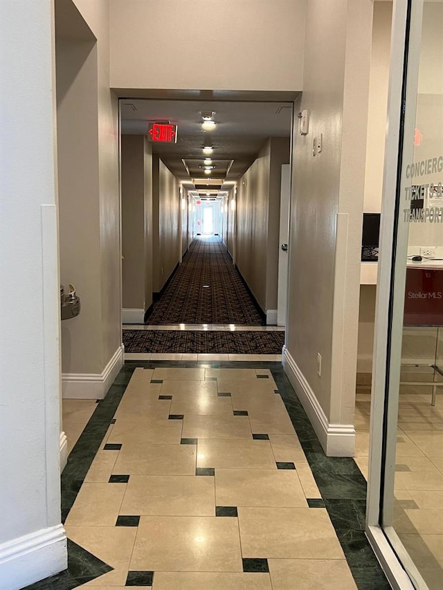 hall with dark tile patterned floors