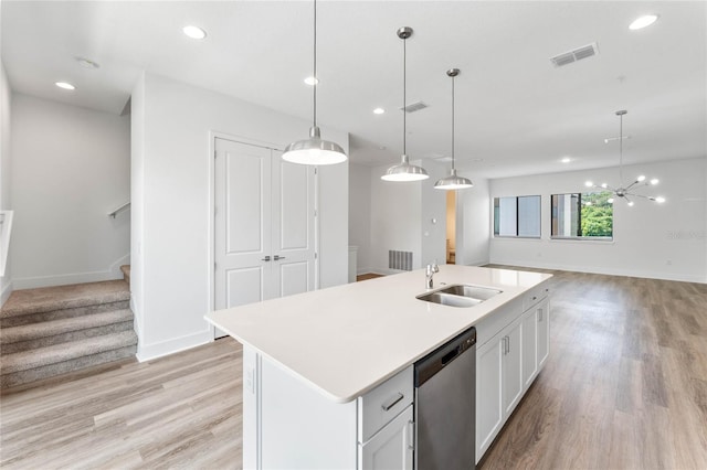 kitchen with white cabinetry, an island with sink, sink, and hanging light fixtures