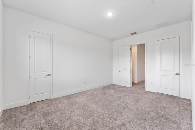 unfurnished bedroom featuring light colored carpet