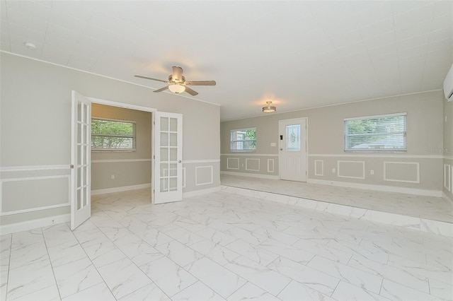 tiled spare room with ceiling fan and french doors