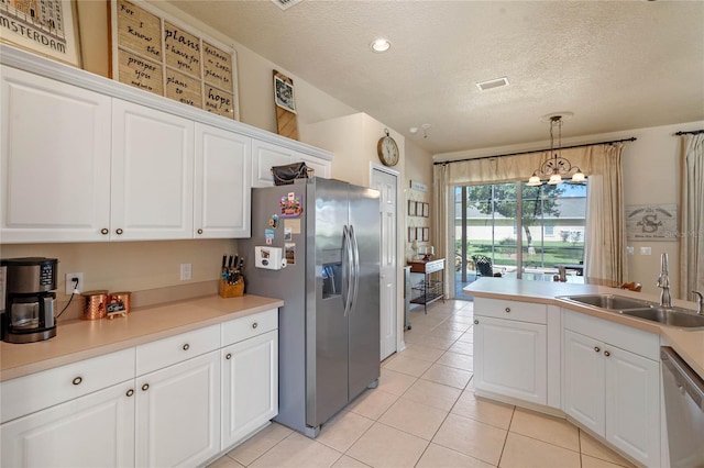 404 Hightower Dr, Debary, FL 32713 - kitchen with stainless steel appliances, a sink, light tile patterned floors, a textured ceiling, and white cabinetry