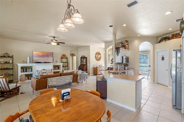 404 Hightower Dr, Debary, FL 32713 - dining area with arched walkways, a textured ceiling, light tile patterned flooring, ceiling fan, and recessed lighting