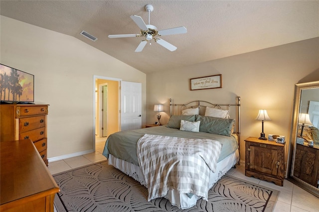 404 Hightower Dr, Debary, FL 32713 - bedroom with vaulted ceiling, light tile patterned floors, a ceiling fan, a textured ceiling, and baseboards
