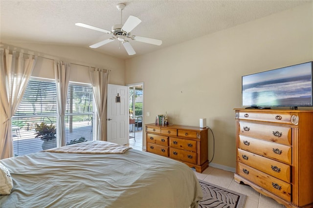 404 Hightower Dr, Debary, FL 32713 - bedroom featuring light tile patterned floors, vaulted ceiling, a textured ceiling, ceiling fan, and baseboards